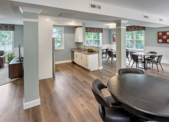 a kitchen and dining room with a table and chairs at Eden & Main 55+ Apartments, Southington , CT 06489