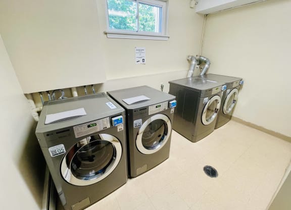 a washer and dryer in a laundry room with a window at Eagle Pointe New London, CT
