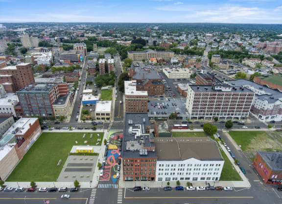 an aerial view of a city with buildings and a green park at 1188 Lofts in Bridgeport