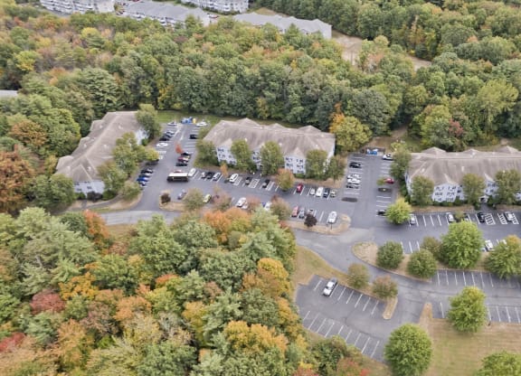 an aerial view of a parking lot with cars and tents