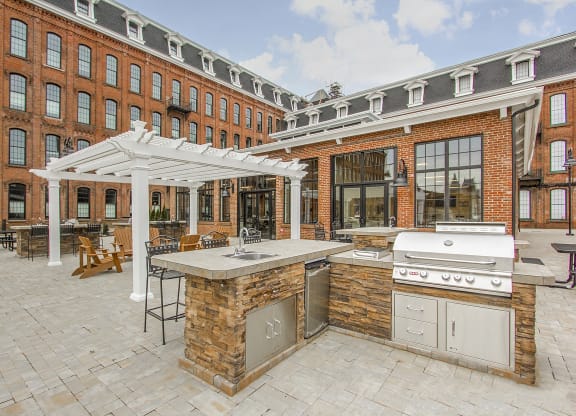 a large outdoor kitchen with a grill and a patio at Ponemah Mills in Taftville, CT, 06380