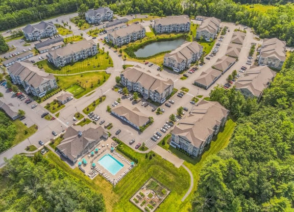 an aerial view of a neighborhood with houses and a pool at The Beacon at Gateway Apartments, Scarborough, ME, 04074