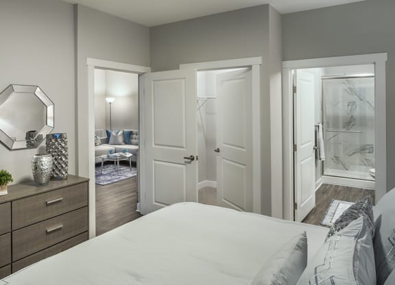 a bedroom with a white bed and a closet at The Beacon at Gateway Apartments, Scarborough, ME, 04074
