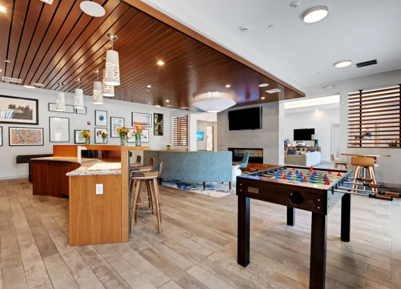 a game room with a pool table and a bar at The Beacon at Gateway Apartments, Scarborough, ME, 04074