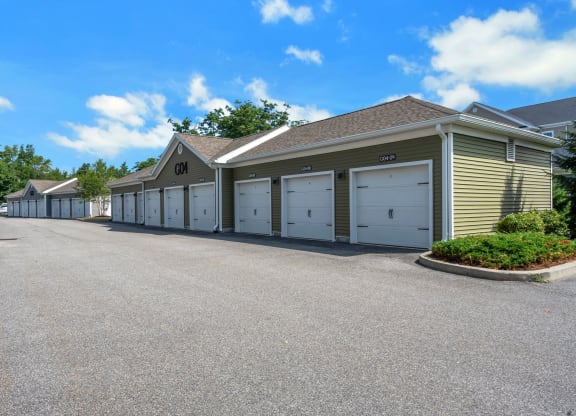 a row of garages with cars parked in front of them at The Beacon at Gateway Apartments, Scarborough, ME, 04074