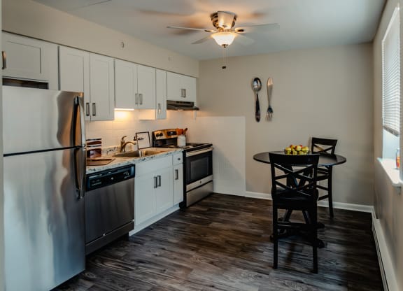 a kitchen with white cabinets and stainless steel appliances at Glen Hollow, Croydon, Pennsylvania