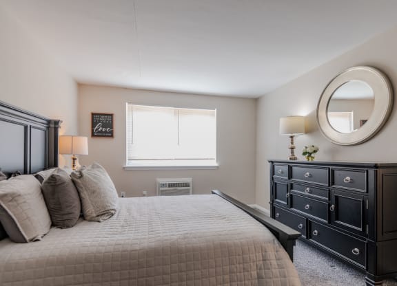 a bedroom with a bed and a dresser and a window at Glen Hollow, Croydon, Pennsylvania