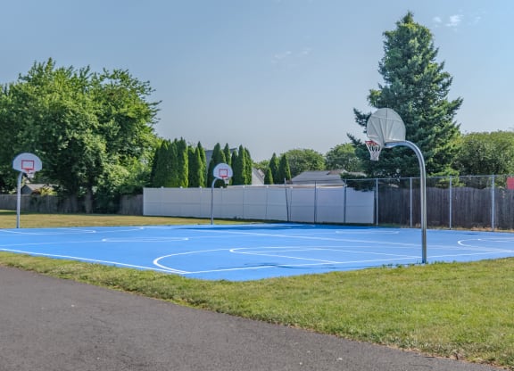 a blue basketball court in a park with two basketball hoops at Glen Hollow, Croydon, Pennsylvania