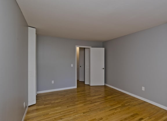 a living room with a hard wood floor and grey walls at Hawkins Meadow in Amherst, MA, 01002