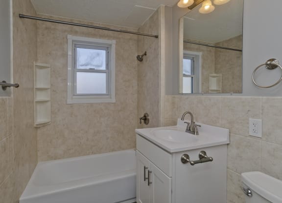 a bathroom with a sink and a tub and a mirror at Laurel Ridge in Northampton, MA, 01060