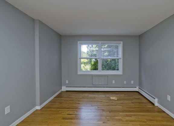interior view of an empty room with wooden floors and a window at Laurel Ridge in Northampton, MA, 01060