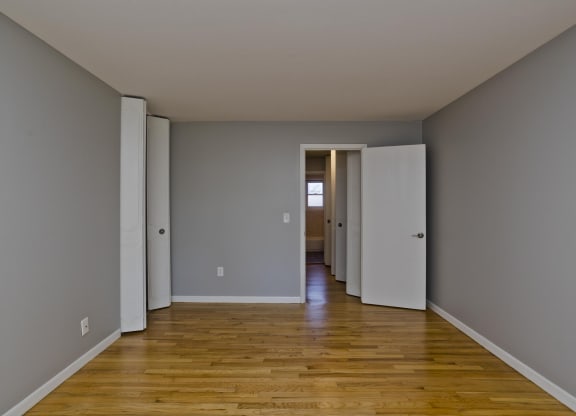 a empty room with wooden floors and grey walls at Laurel Ridge in Northampton, MA, 01060