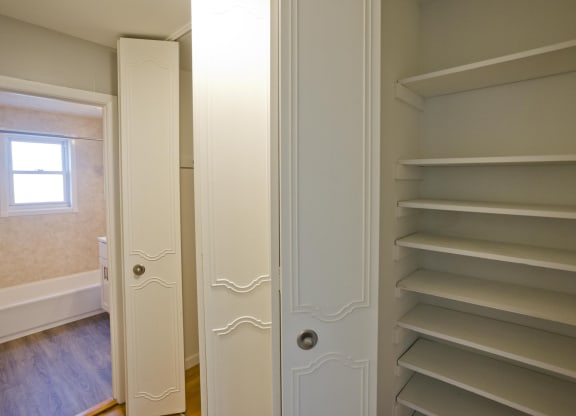 a walk in closet with shelves and a door to a bathroom at Laurel Ridge in Northampton, MA, 01060