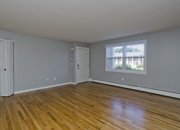 an empty living room with wood floors and a window at Laurel Ridge in Northampton, MA, 01060