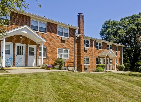 the front of a brick apartment building with a lawn and a porch at Laurel Ridge in Northampton, MA, 01060