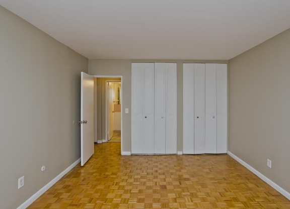 a living room with a wood floor and white closets on the wall at Park Edge, Springfield, MA, 13502