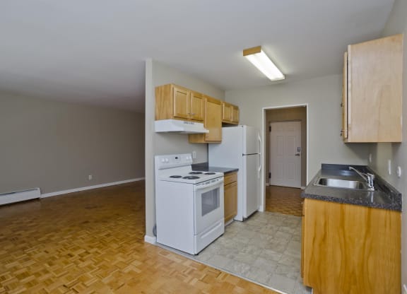 a kitchen with a stove and a refrigerator and a sink at Park Edge, Springfield, MA