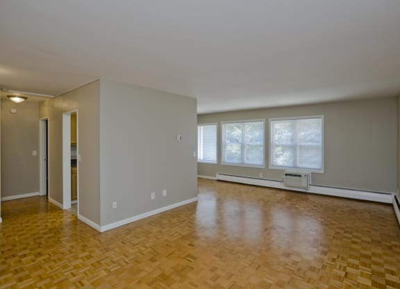 an empty living room with a hard wood floor and a window at Park Edge, Springfield, Massachusetts