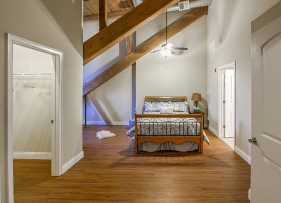 an attic bedroom with a bed and a closet at Ponemah Mills in Taftville, CT, 06380