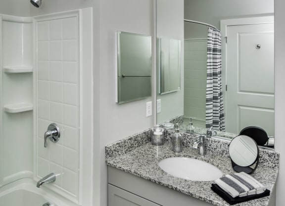 a bathroom with a sink and a shower and a mirror at The Residences at Crosstree, Freeport, ME, 04096