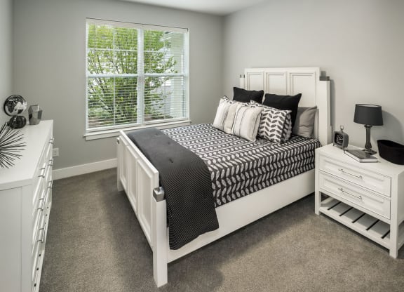 a bedroom with a white bed and a window at The Residences at Crosstree, Freeport