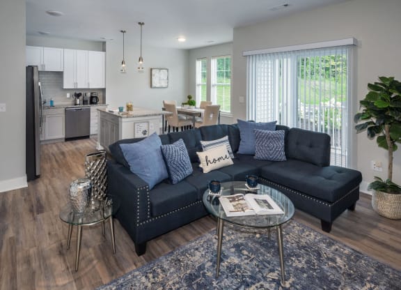 a living room with a couch and a table at The Residences at Crosstree, Freeport, ME