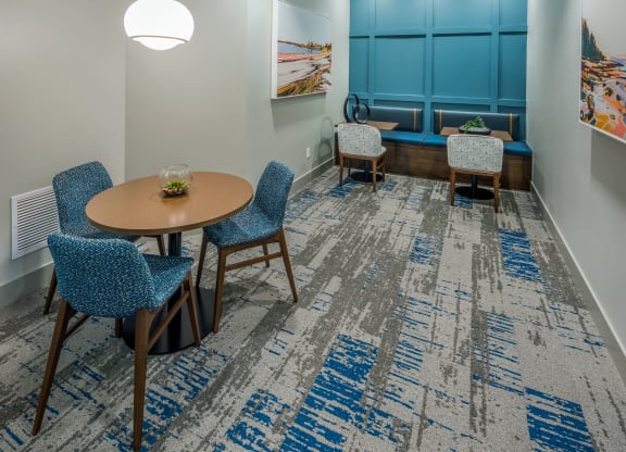 a conference room with blue chairs and a table at The Residences at Crosstree, Freeport, ME, 04096