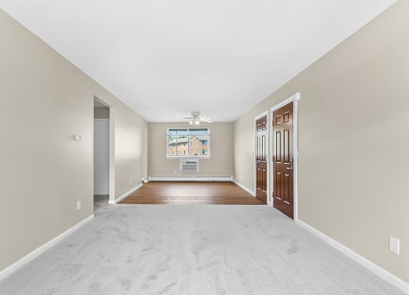 a spacious living room with a white carpet and a door to a bedroom at Rose Hill Estates, Norwich, Connecticut