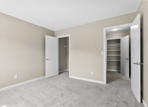 an empty bedroom with three closets and a carpeted floor at Rose Hill Estates, Connecticut, 06360