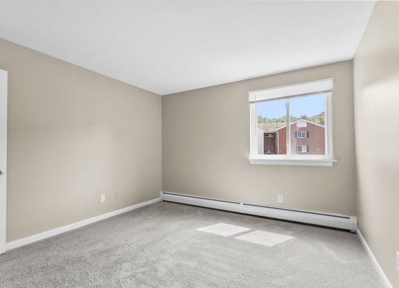 an empty room with carpet and a window at Rose Hill Estates, Norwich, CT, 06360