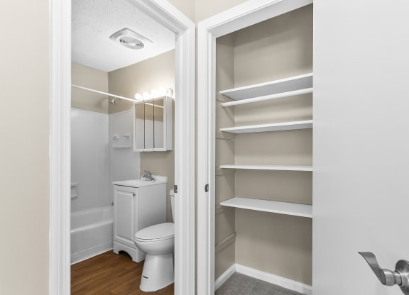 a bathroom with a toilet and a closet at Rose Hill Estates, Norwich, CT