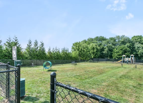 a park with a playground and a chain link fence at Rose Hill Estates, Norwich, CT, 06360