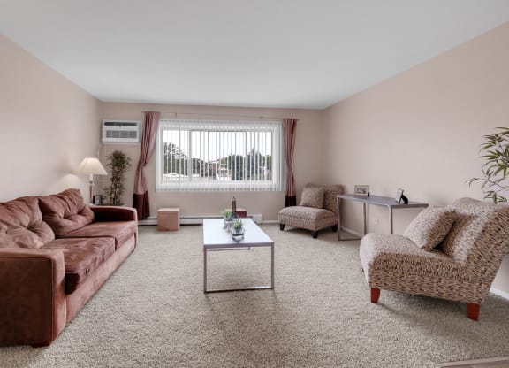 a living room with a leather couch and a coffee table at St Charles Square Apartments, Carol Stream, IL, 60188