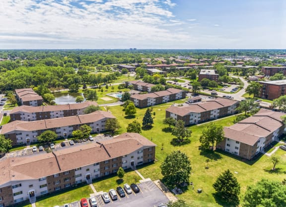an aerial view of a group of buildings in a city at St Charles Square Apartments, Carol Stream, IL