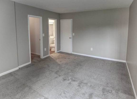 a empty living room with carpet and a door to a bathroom at Stepny Place, Rocky Hill, CT, 06067