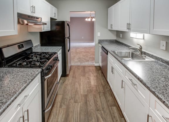 a kitchen with white cabinets and stainless steel appliances at Stepny Place, Rocky Hill, 06067