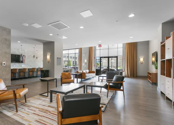 a lounge area with chairs and tables in a lobby at 1188 Lofts, Bridgeport, 06604