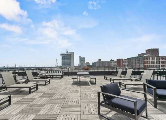 a roof deck with lounge chairs and a view of the city at 1188 Lofts, Connecticut