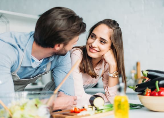 younger couple cooking together