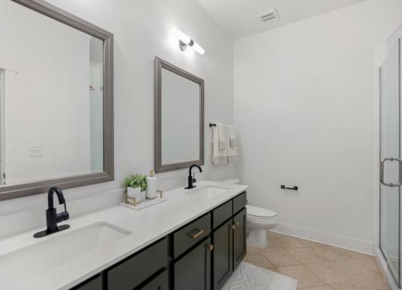 A bathroom with a sink, mirror, and toilet.