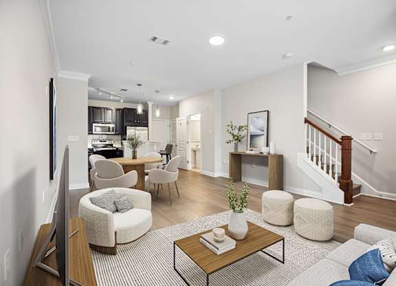 A living room with a couch, chairs, and a coffee table.