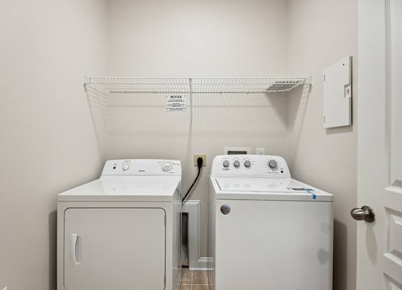 A white dryer and washer in a laundry room.