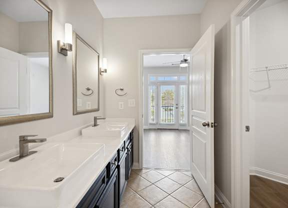 A bathroom with a white sink and a mirror.