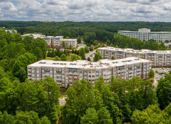 A large building complex surrounded by trees.