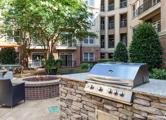 A stone wall with a grill on top of it.
