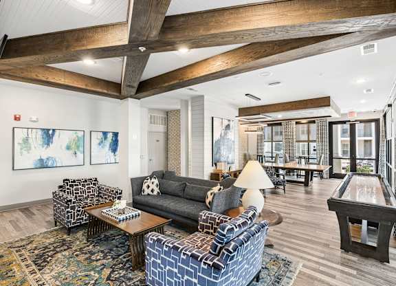 A living room with a pool table and a fireplace.