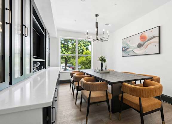 A modern dining room with a large table and chairs.