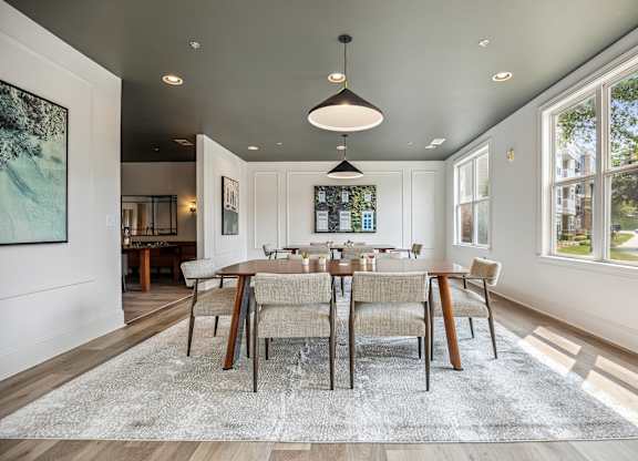 A modern co-working space with a large table and chairs.