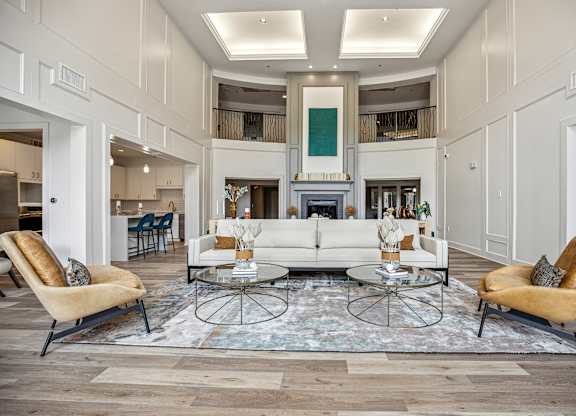 A living room with a white sofa and two chairs.