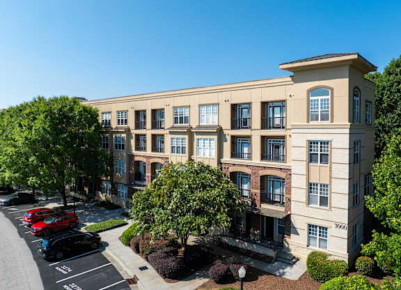 A large building with a parking lot in front of it.